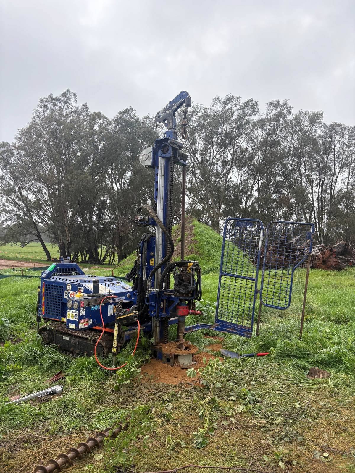 Environmental scientist collecting soil samples during a Detailed Site Investigation using in-house drilling equipment